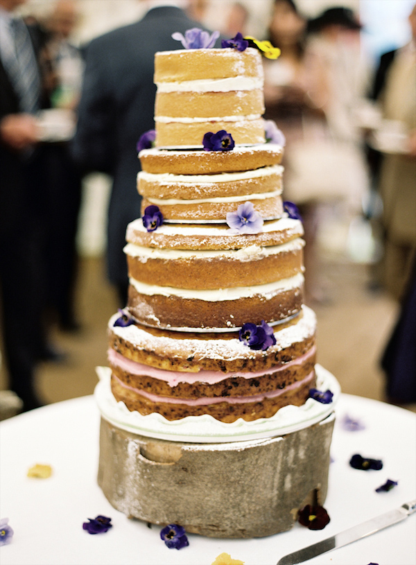 Rustic, homemade tiered wedding cake with purple flower details - Photo by Aneta MAK